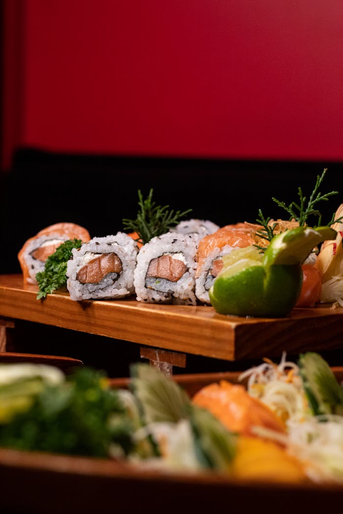 Delicious sushi rolls artfully arranged on a wooden platter, perfect for culinary promotions.
